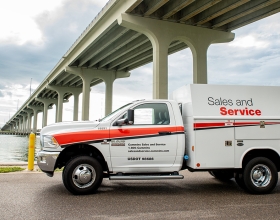 Sales and Service truck parked by bridge